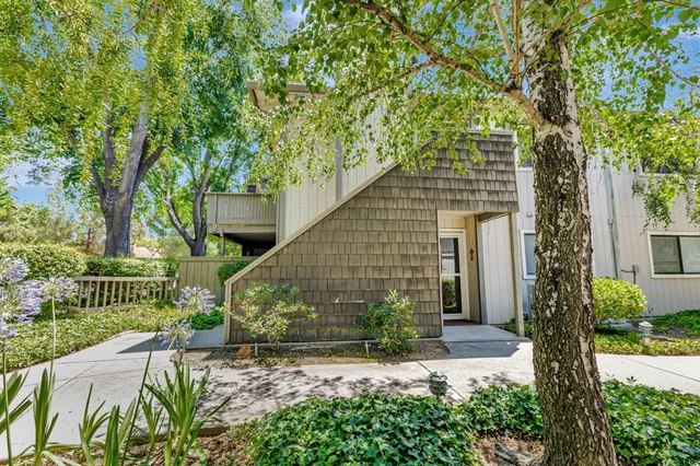 a front view of a house with a yard garage and outdoor seating