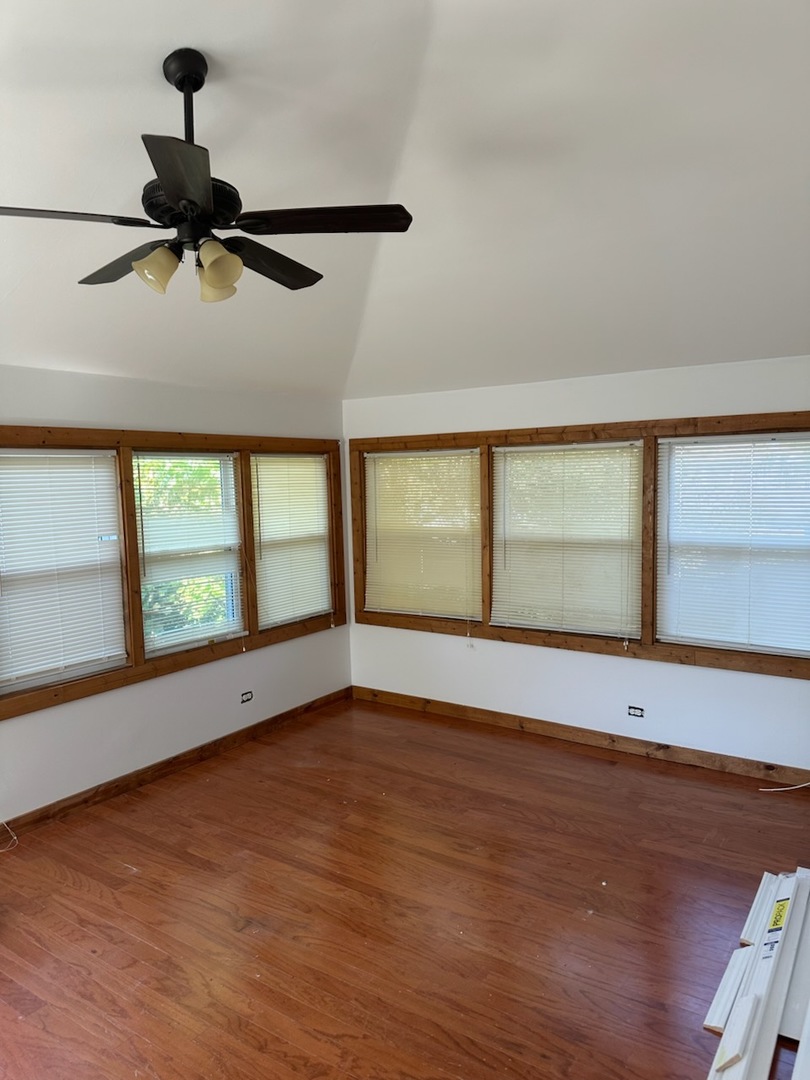 1204 North Hickory Terrace Round Lake Beach, IL 60073 - Photo 2 of 6 wooden floor in an empty room with a window