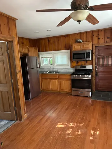 a kitchen with stainless steel appliances a stove a refrigerator and a sink