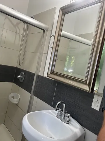 a bathroom with a sink and mirror