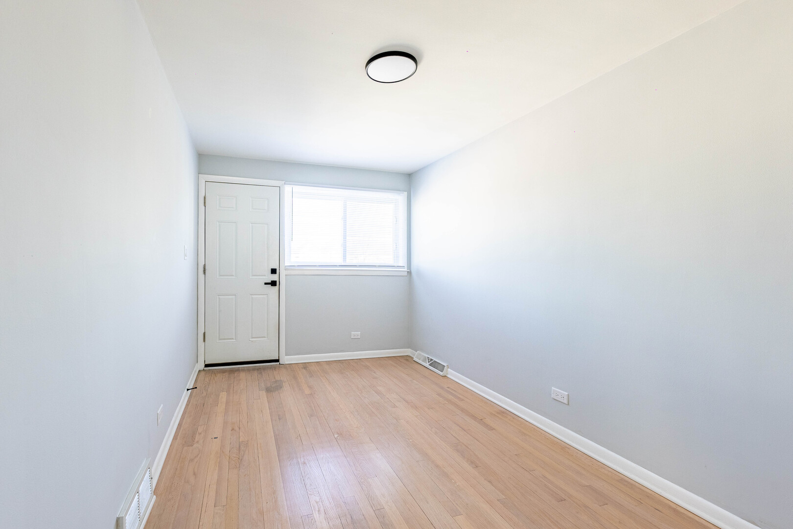 4914 West 32nd Place, Unit 2 Cicero, IL 60804 - Photo 11 of 26 a view of a room that has wooden floor and window