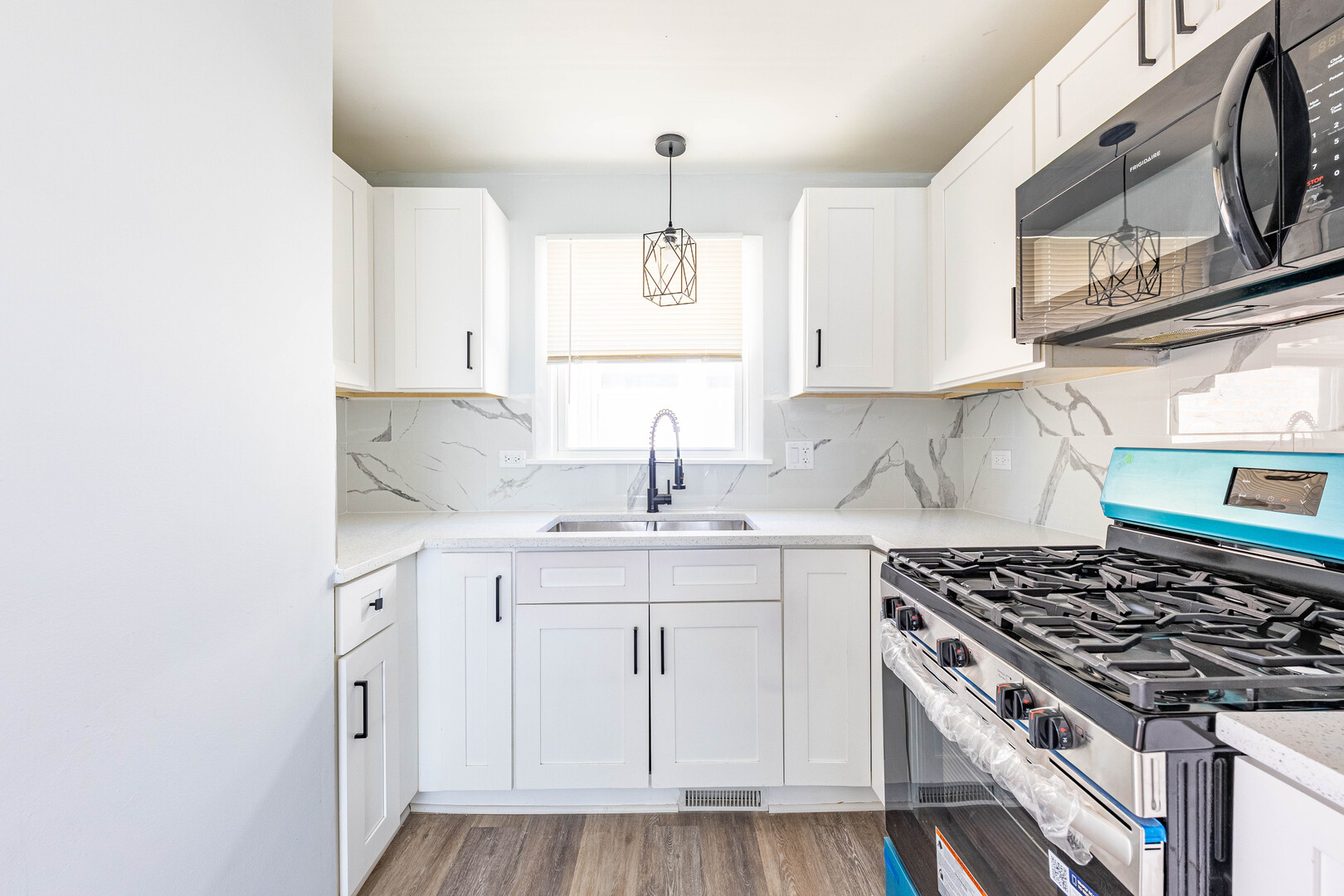 4914 West 32nd Place, Unit 2 Cicero, IL 60804 - Photo 8 of 26 a kitchen with white cabinets stainless steel appliances and sink