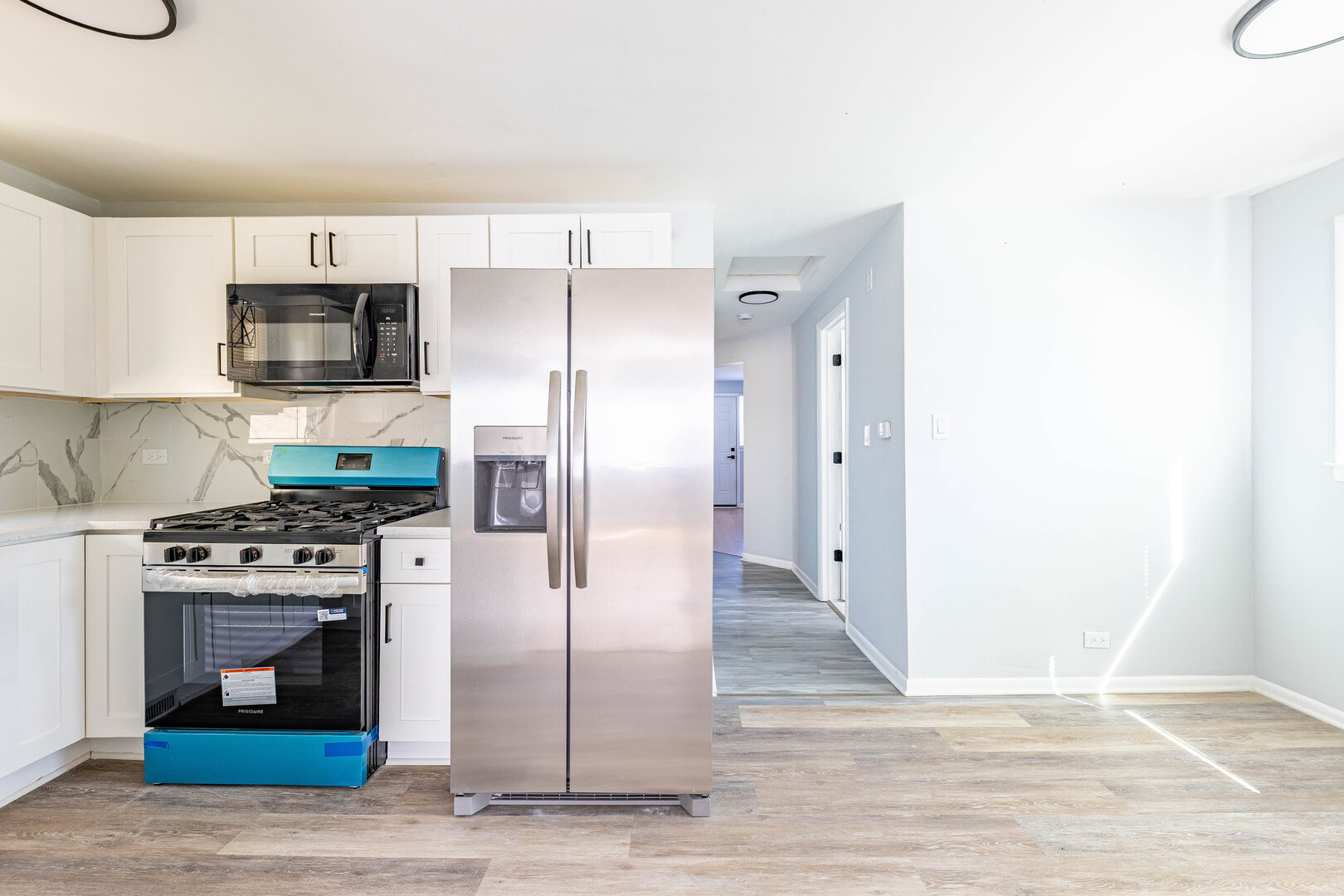 4914 West 32nd Place, Unit 2 Cicero, IL 60804 - Photo 9 of 26 a kitchen with stainless steel appliances granite countertop a stove a refrigerator and a microwave