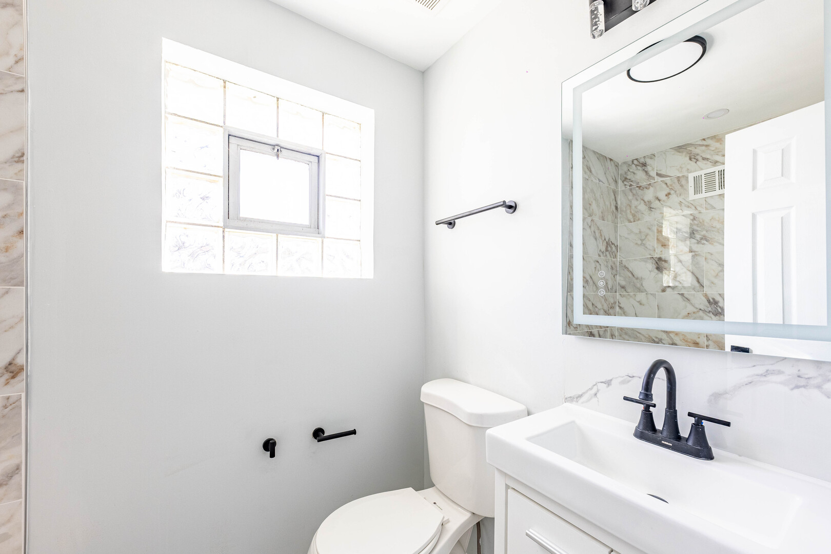 4914 West 32nd Place, Unit 2 Cicero, IL 60804 - Photo 10 of 26 a bathroom with a toilet sink and mirror