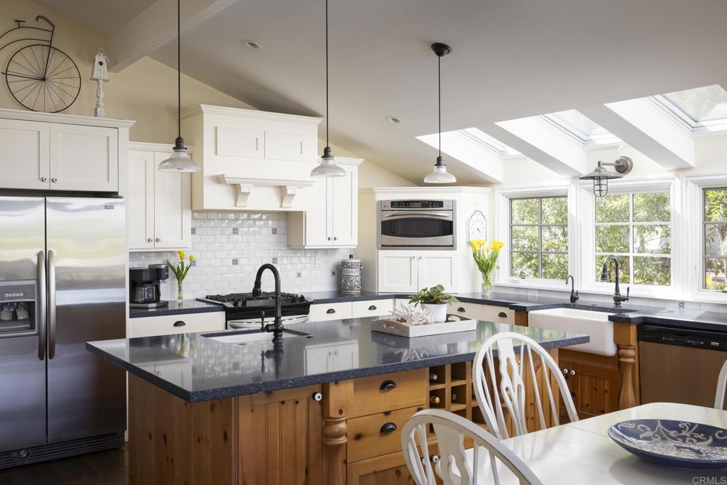 594 Rancho Santa Fe Road Encinitas, CA 92024 - Photo 11 of 47 a kitchen with stainless steel appliances granite countertop a sink a stove and a refrigerator
