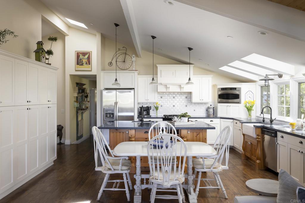 594 Rancho Santa Fe Road Encinitas, CA 92024 - Photo 12 of 47 a view of a dining room with furniture window and wooden floor