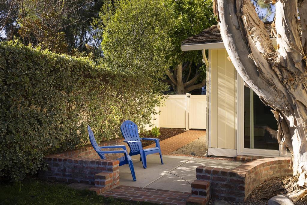 594 Rancho Santa Fe Road Encinitas, CA 92024 - Photo 34 of 47 a backyard of a house with table and chairs