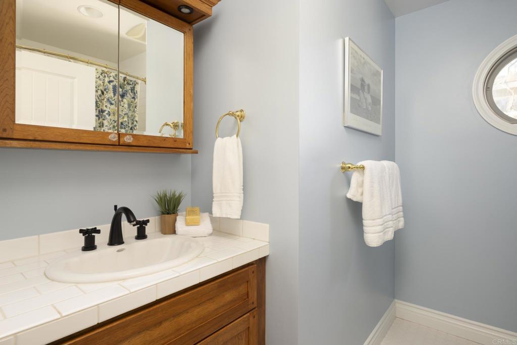 594 Rancho Santa Fe Road Encinitas, CA 92024 - Photo 36 of 47 a bathroom with a sink and a mirror