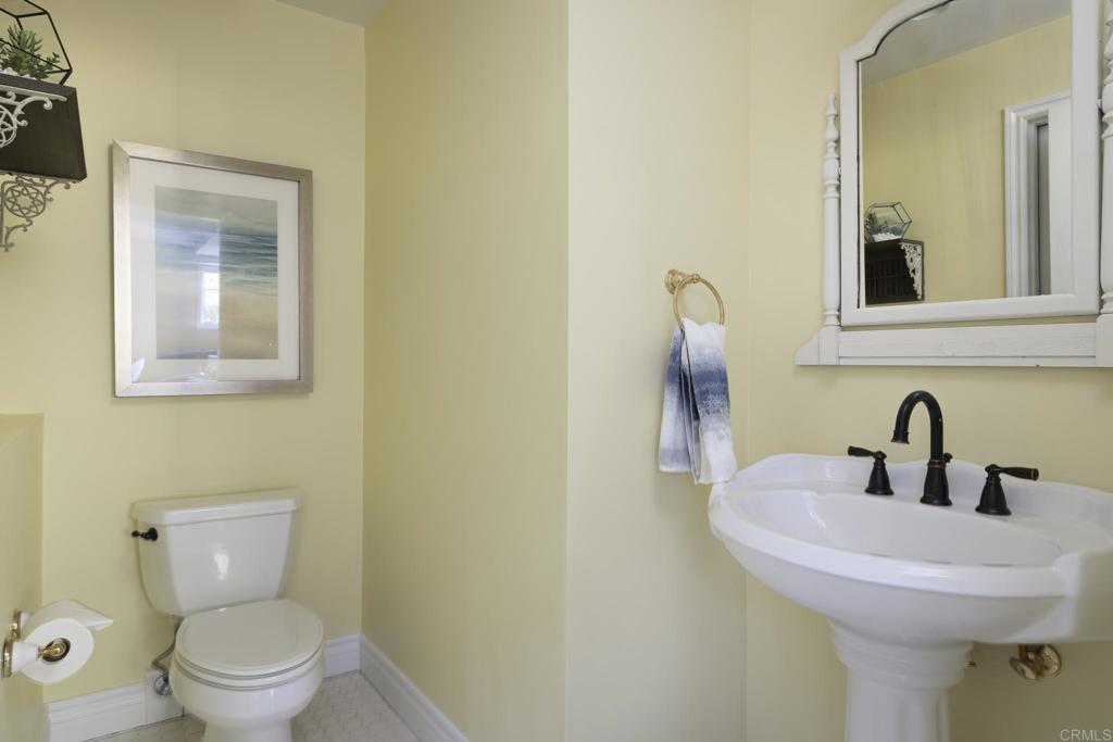 594 Rancho Santa Fe Road Encinitas, CA 92024 - Photo 43 of 47 a bathroom with a toilet sink and mirror