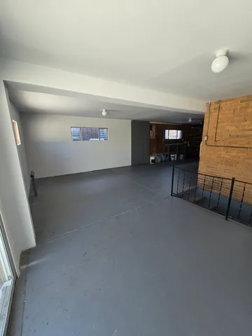 a view of a livingroom with furniture and staircase
