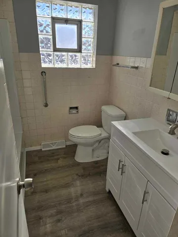 a bathroom with a toilet sink and mirror