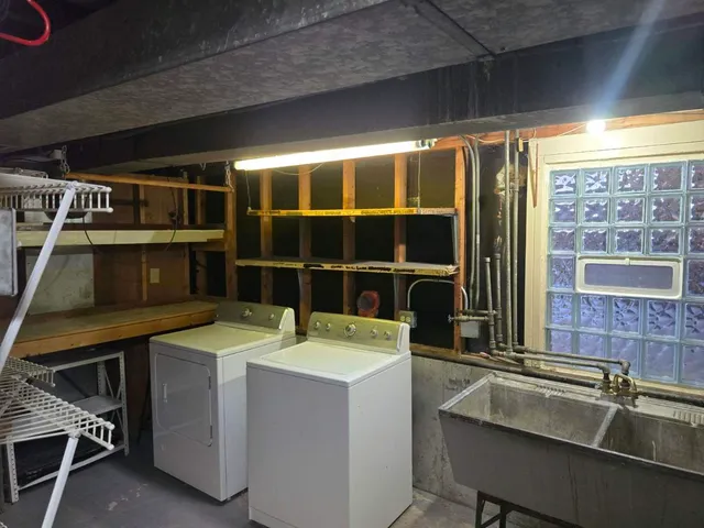 a utility room with a sink and a large window