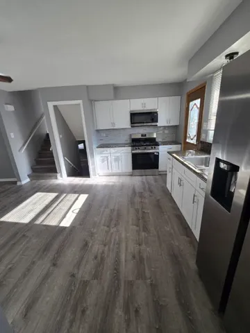 a kitchen with granite countertop a stove top oven and sink