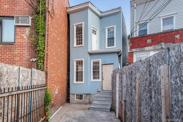 a view of a brick house with many windows