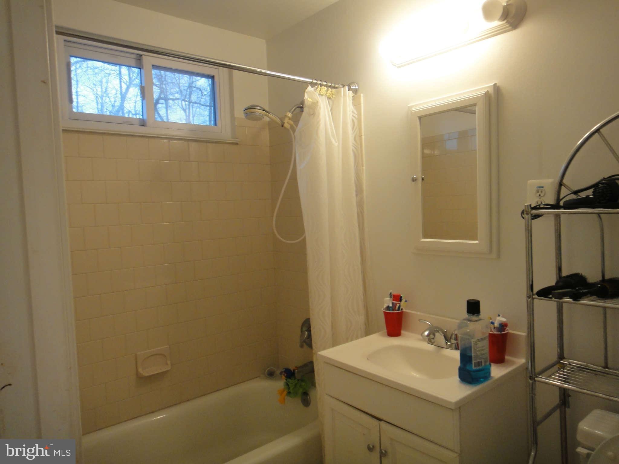 6221 Frontier Drive Springfield, VA 22150 - Photo 14 of 18 a bathroom with a sink a toilet and shower