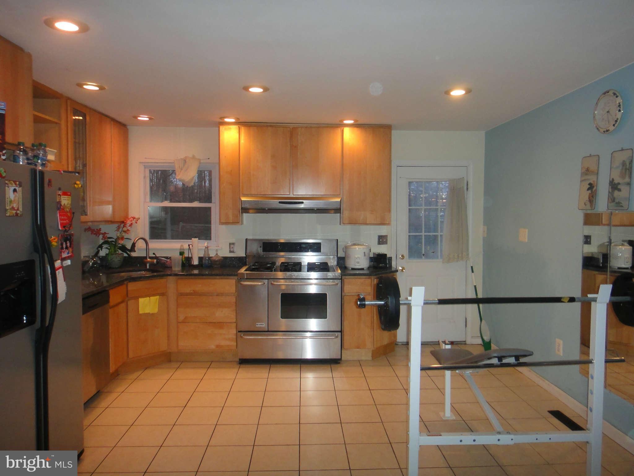 6221 Frontier Drive Springfield, VA 22150 - Photo 5 of 18 a kitchen with stainless steel appliances granite countertop a sink a stove and a refrigerator