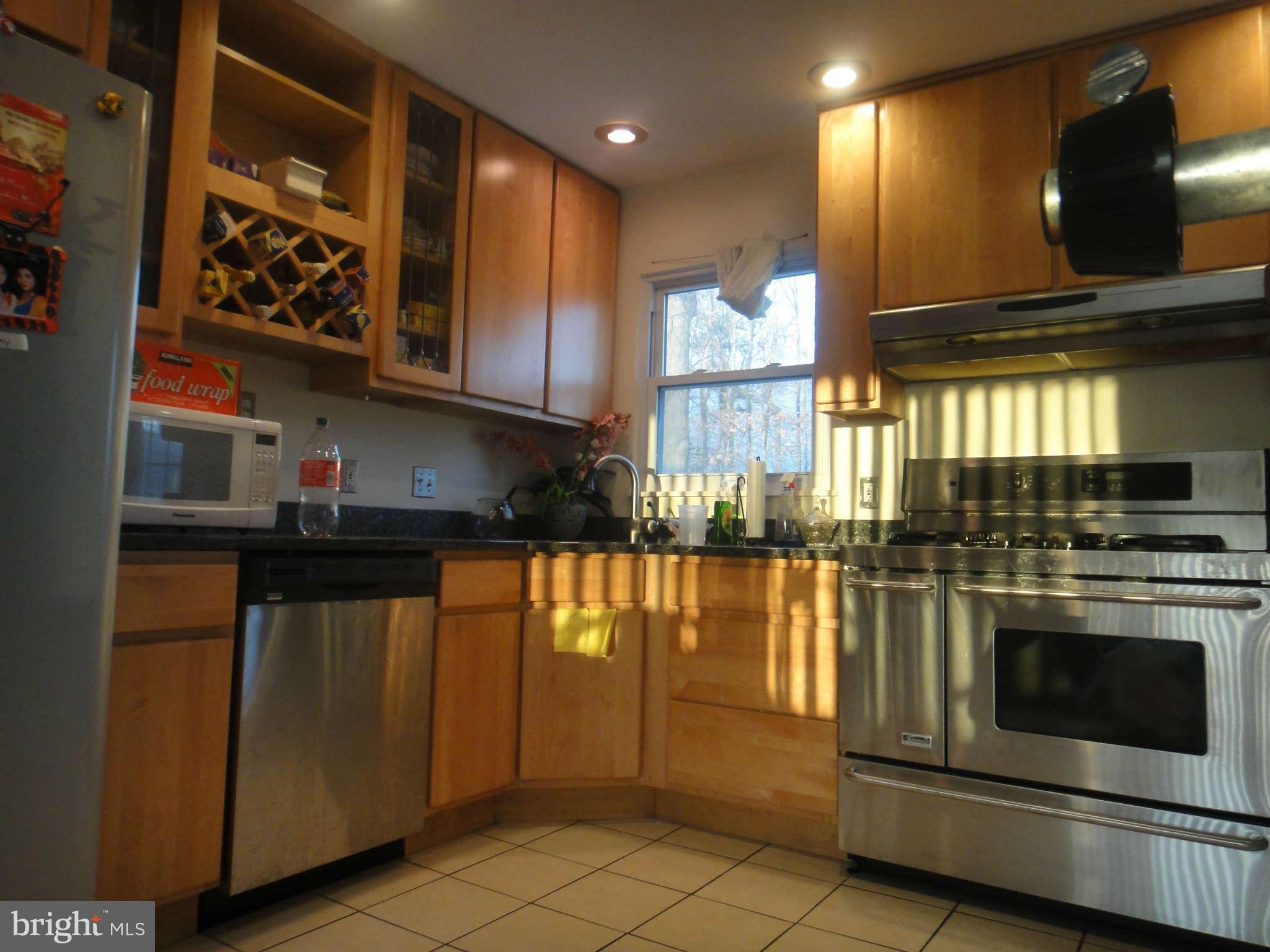 6221 Frontier Drive Springfield, VA 22150 - Photo 6 of 18 a kitchen with stainless steel appliances granite countertop a stove a sink and a microwave