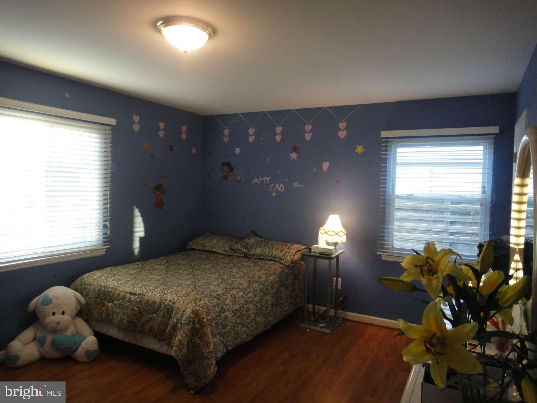 6221 Frontier Drive Springfield, VA 22150 - Photo 9 of 18 a bedroom with a bed mirror and a window