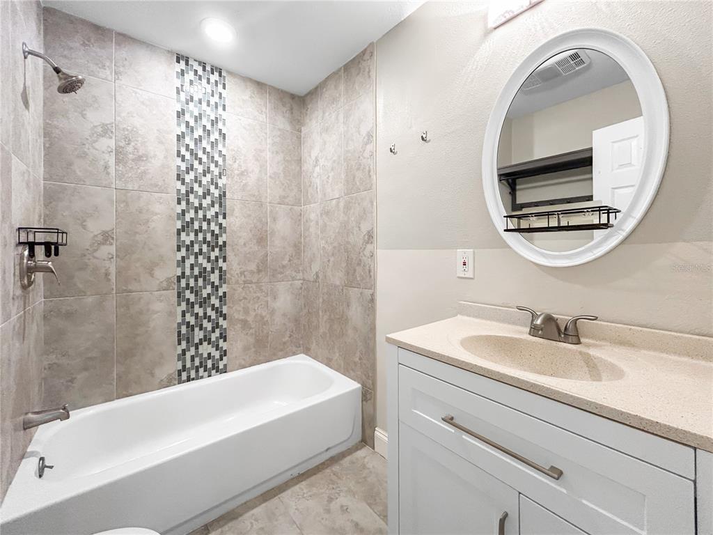 133 18th Street Northwest Ruskin, FL 33570 - Photo 14 of 25 a bathroom with a sink a bathtub and a mirror