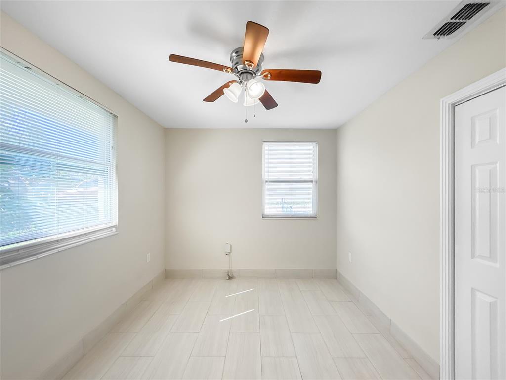 133 18th Street Northwest Ruskin, FL 33570 - Photo 15 of 25 an empty room with windows and chandelier fan
