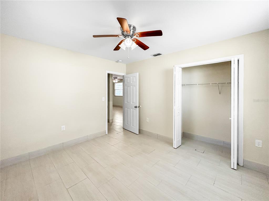 133 18th Street Northwest Ruskin, FL 33570 - Photo 20 of 25 an empty room with closet and windows