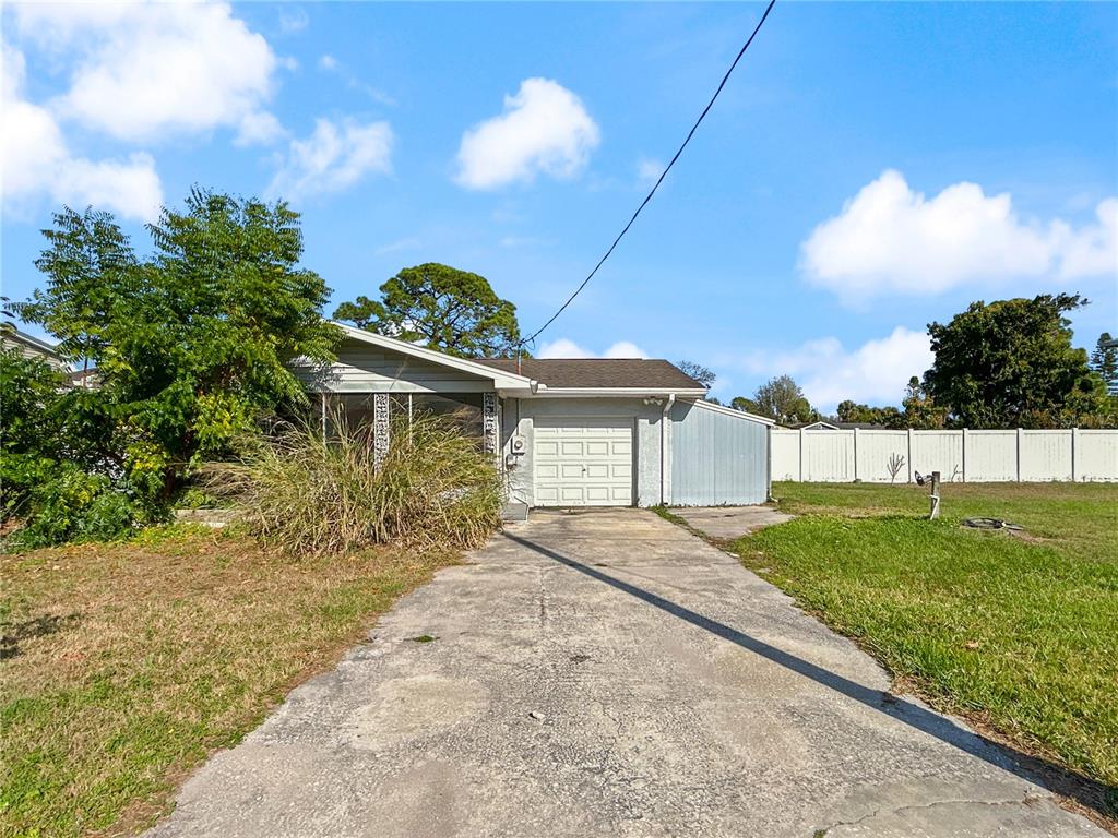 133 18th Street Northwest Ruskin, FL 33570 - Photo 2 of 25 a front view of a house with a yard and garage