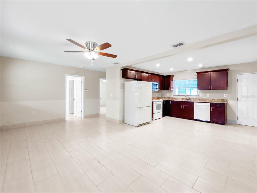133 18th Street Northwest Ruskin, FL 33570 - Photo 9 of 25 a view of kitchen with refrigerator stove microwave and cabinets