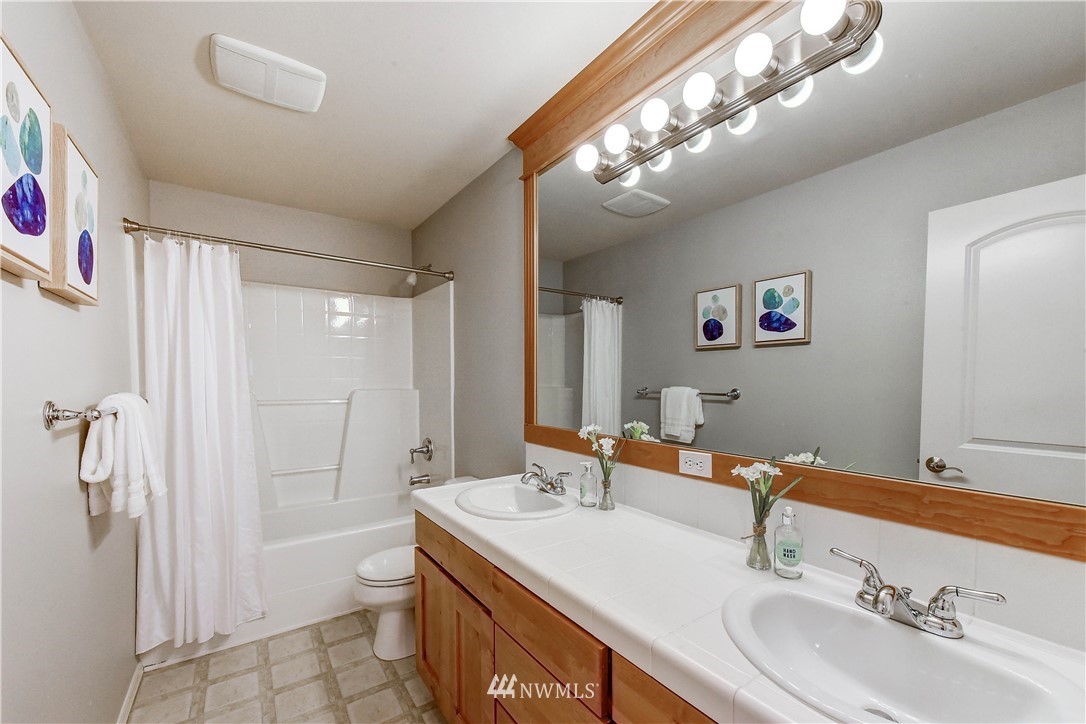 20903 Pioneer Way Edmonds, WA 98026 - Photo 17 of 21 a bathroom with a sink double vanity and a mirror
