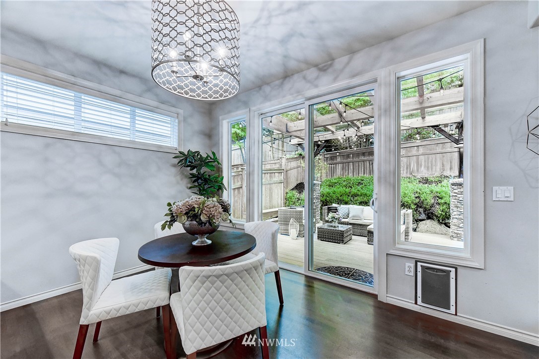 20903 Pioneer Way Edmonds, WA 98026 - Photo 5 of 21 a dining room with furniture a chandelier and wooden floor
