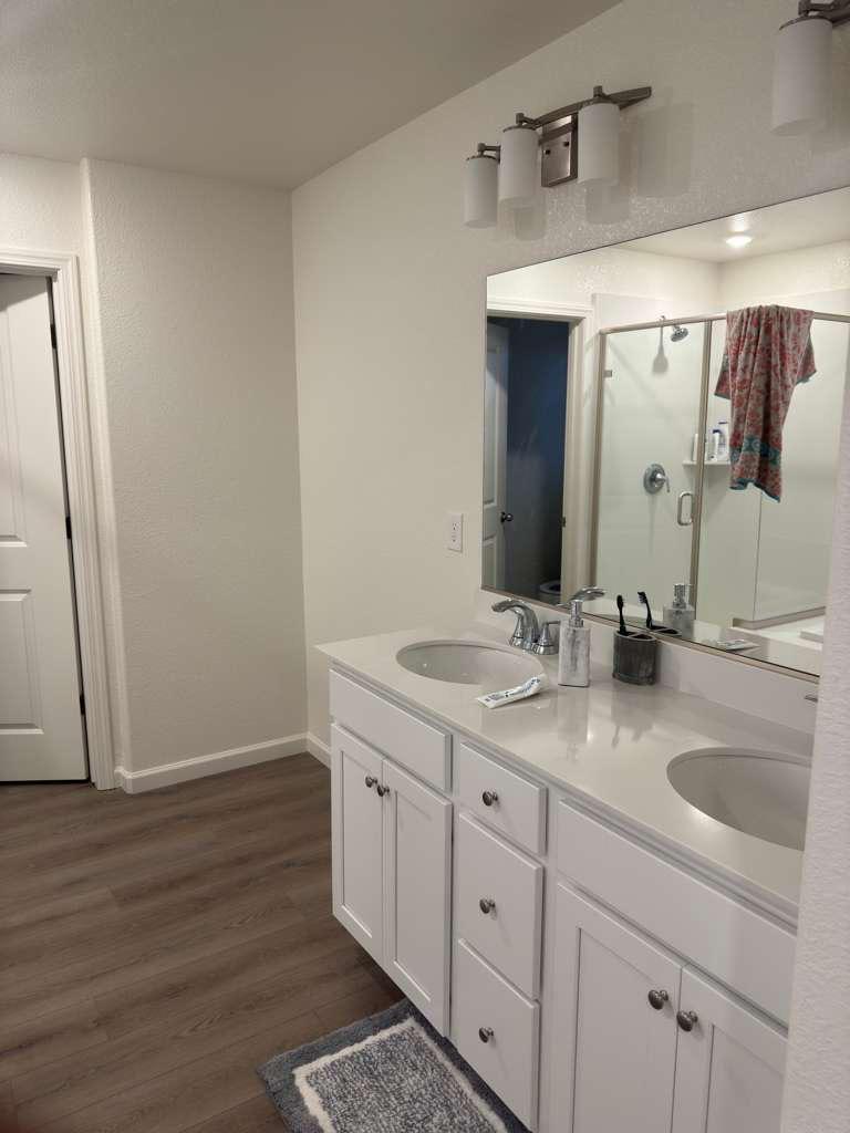 1808 Apiary Way Hughson, CA 95326 - Photo 9 of 20 a bathroom with a double vanity sink and mirror