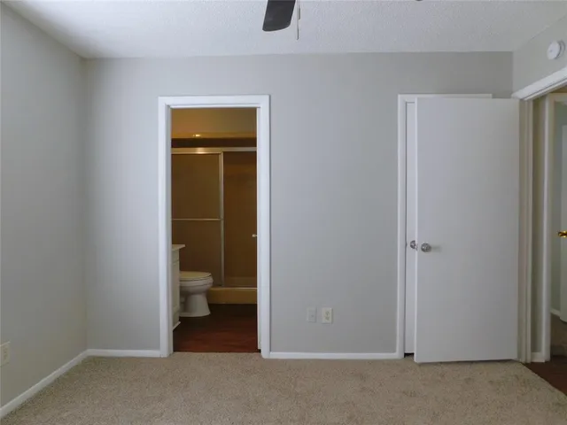 a view of an empty room with toilet and a window