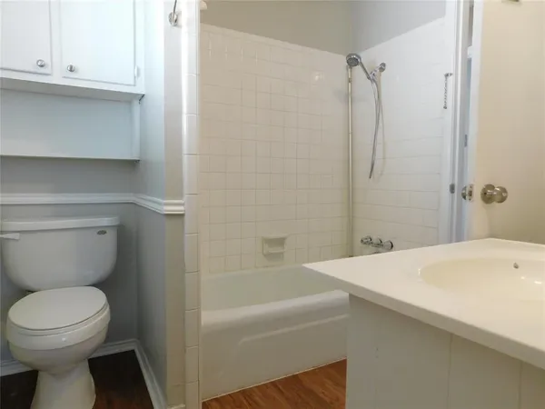 a bathroom with a sink a toilet and bathtub