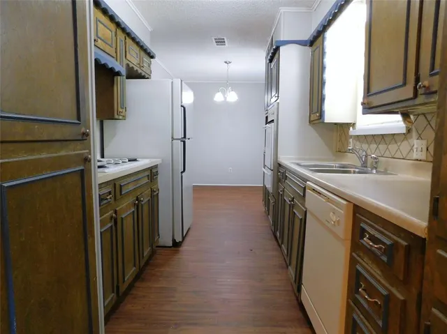a kitchen with a sink stove and refrigerator