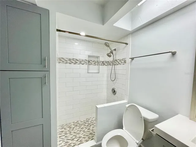 a bathroom with a shower toilet and sink