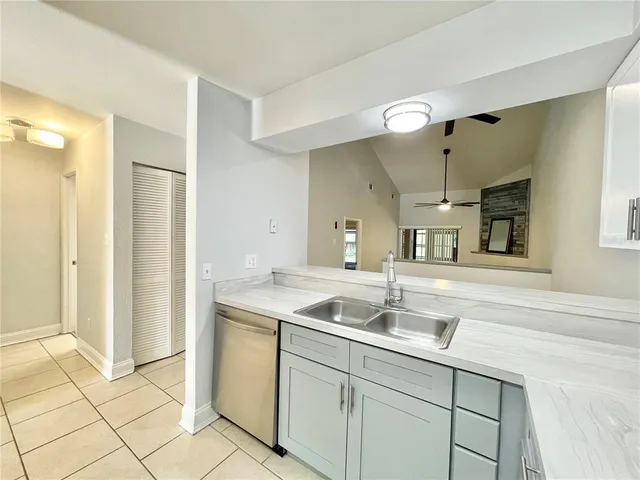 a kitchen with a sink and a refrigerator