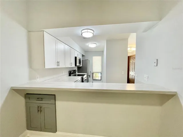 a view of a kitchen with a sink dishwasher microwave oven and cabinets