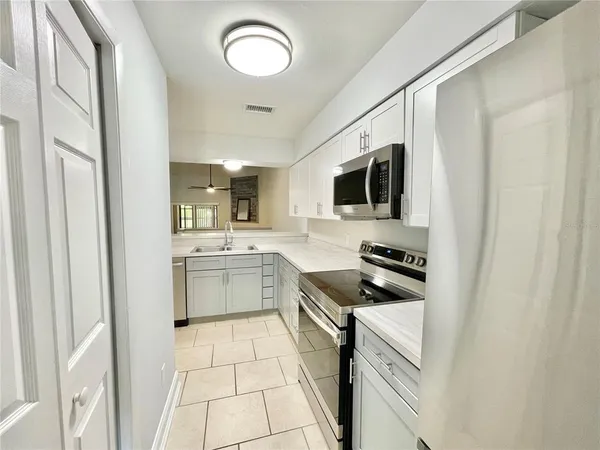 a kitchen with a sink cabinets and stainless steel appliances