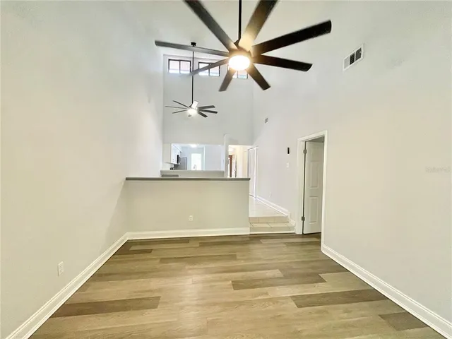 a view of a room with wooden floor