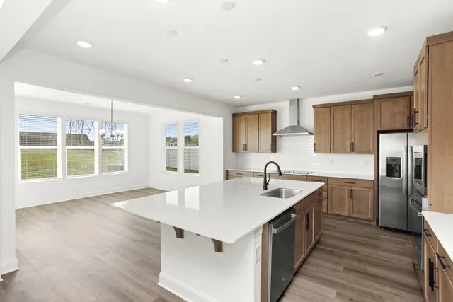 a kitchen with a sink window and refrigerator