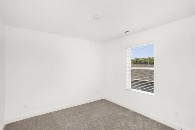 a bedroom with bed furniture and a large window
