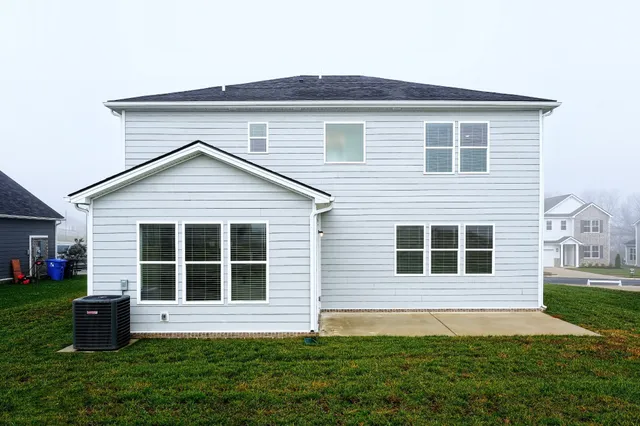 a sign board with tall trees