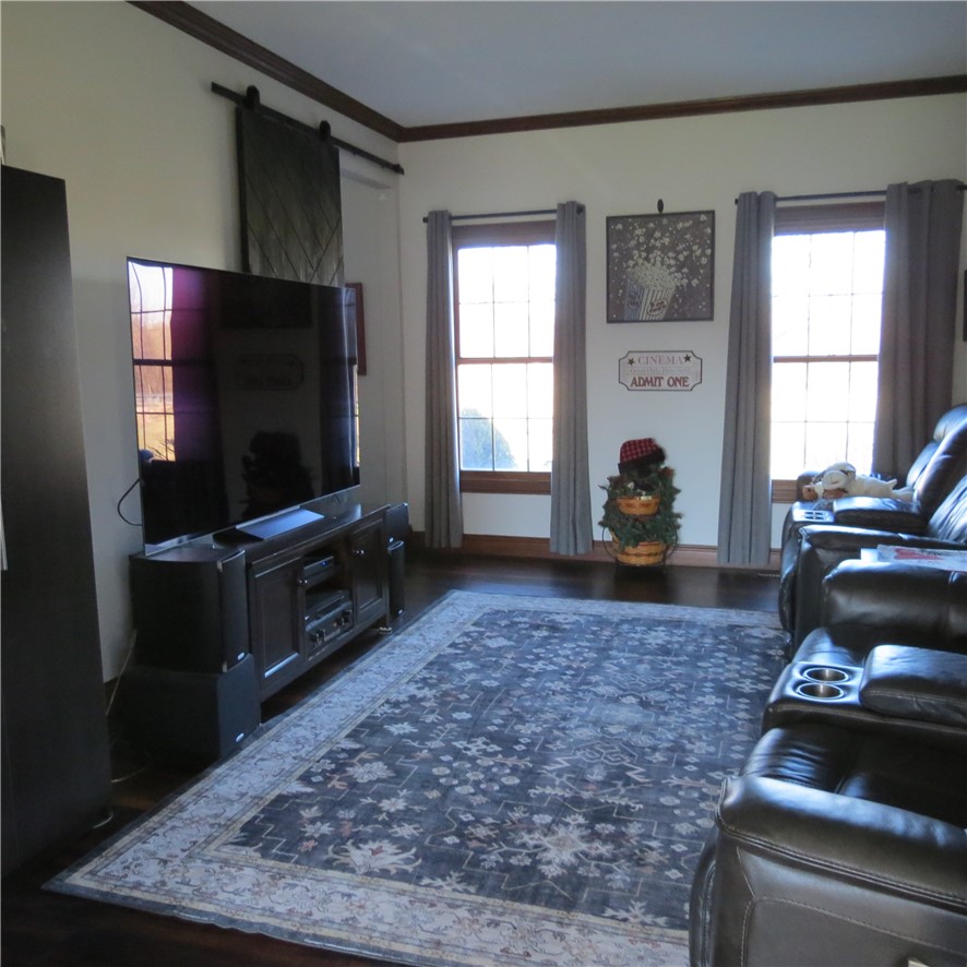 10160 Lochard Road Sidney, OH 45365 - Photo 6 of 41 This living area features rich hardwood floors and abundant natural light.
