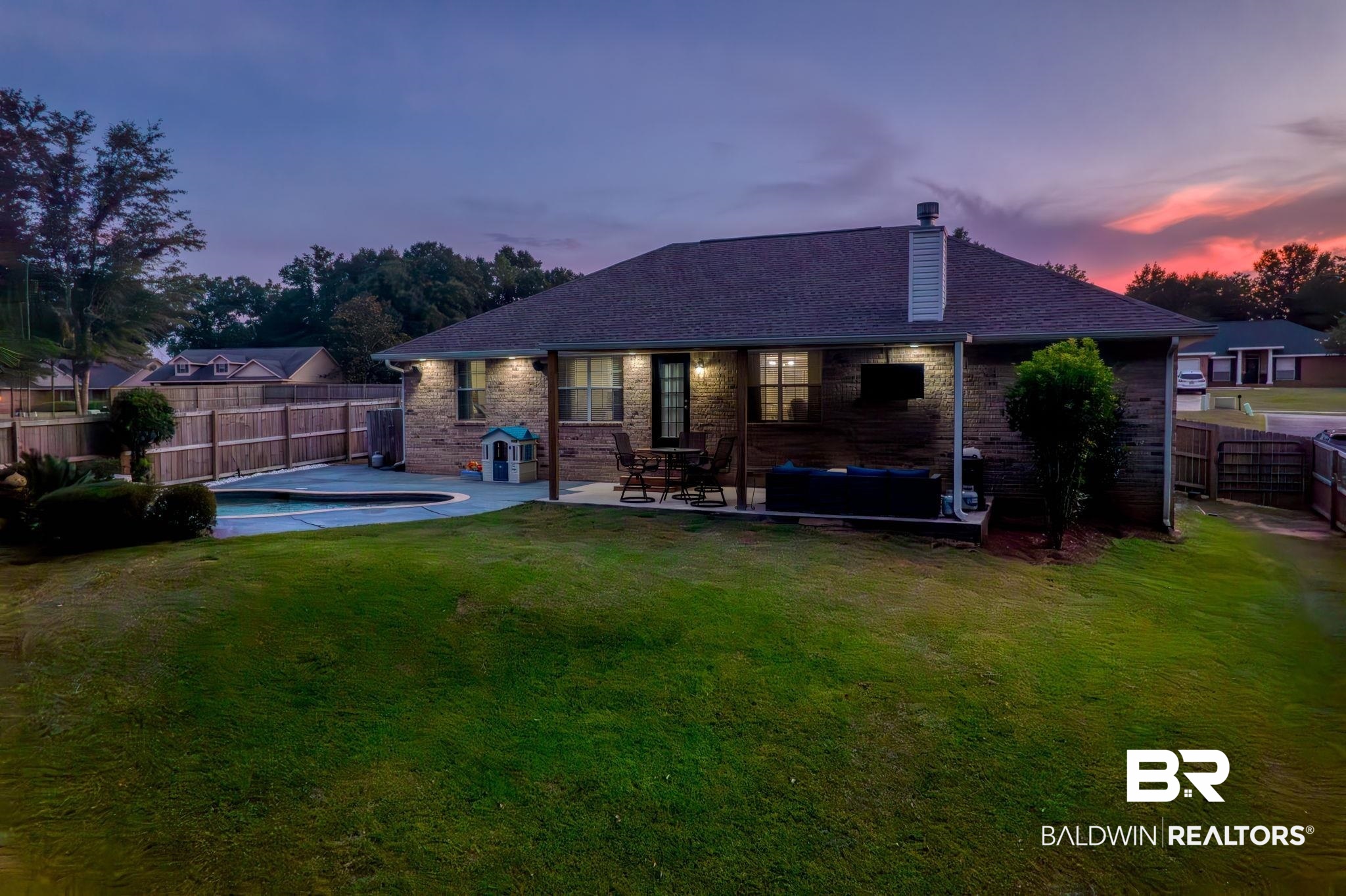 28246 Turkey Branch Drive Daphne, AL 36526 - Photo 35 of 41 Back house at dusk featuring a patio area and a yard