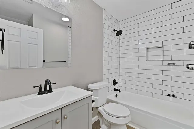 a bathroom with a sink a toilet and a bathtub