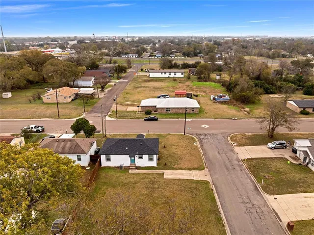 an aerial view of residential houses with outdoor space