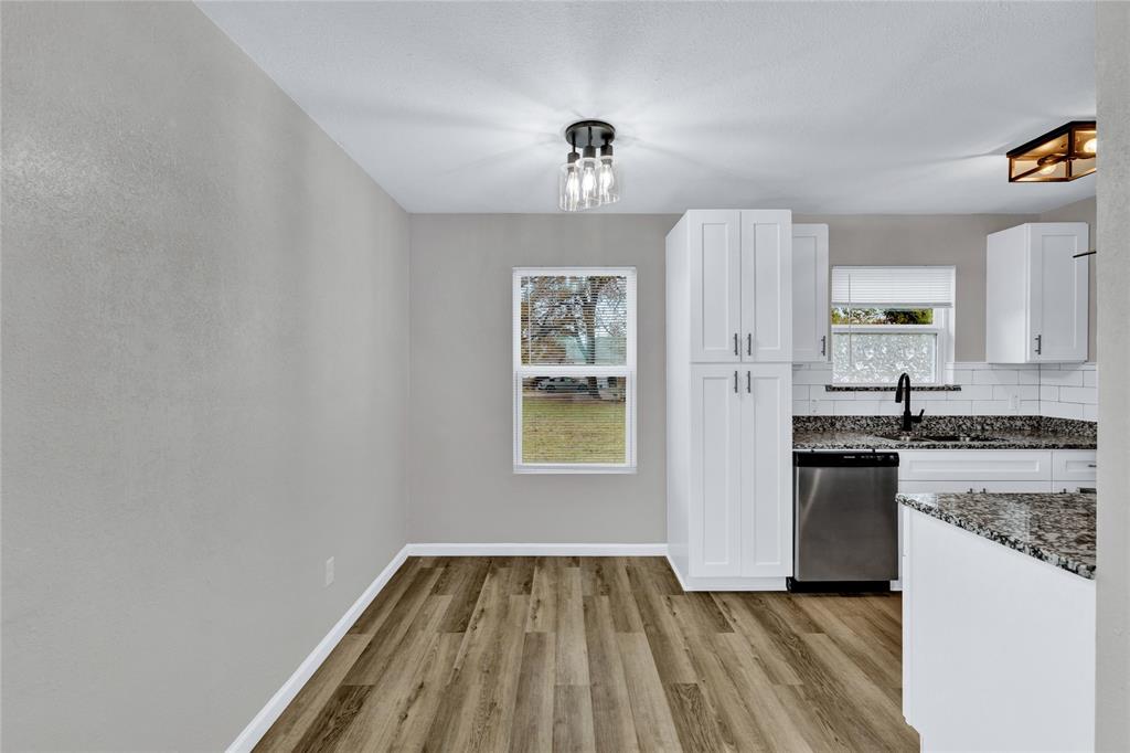 1600 Faulkner Lane Waco, TX 76704 - Photo 8 of 26 a kitchen with granite countertop white cabinets and stainless steel appliances