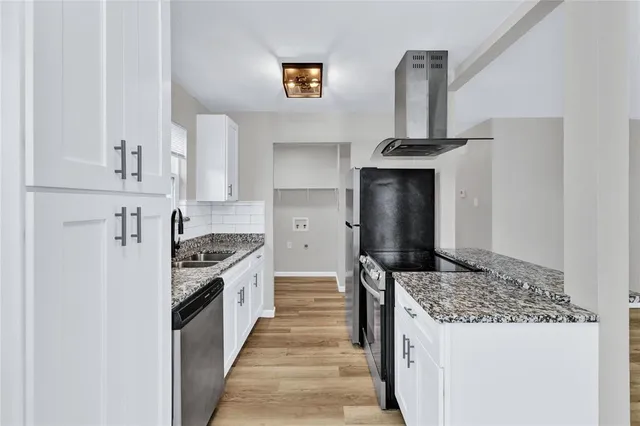 a kitchen with stainless steel appliances granite countertop a stove and a sink
