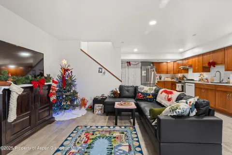 a living room filled with furniture and a flat screen tv