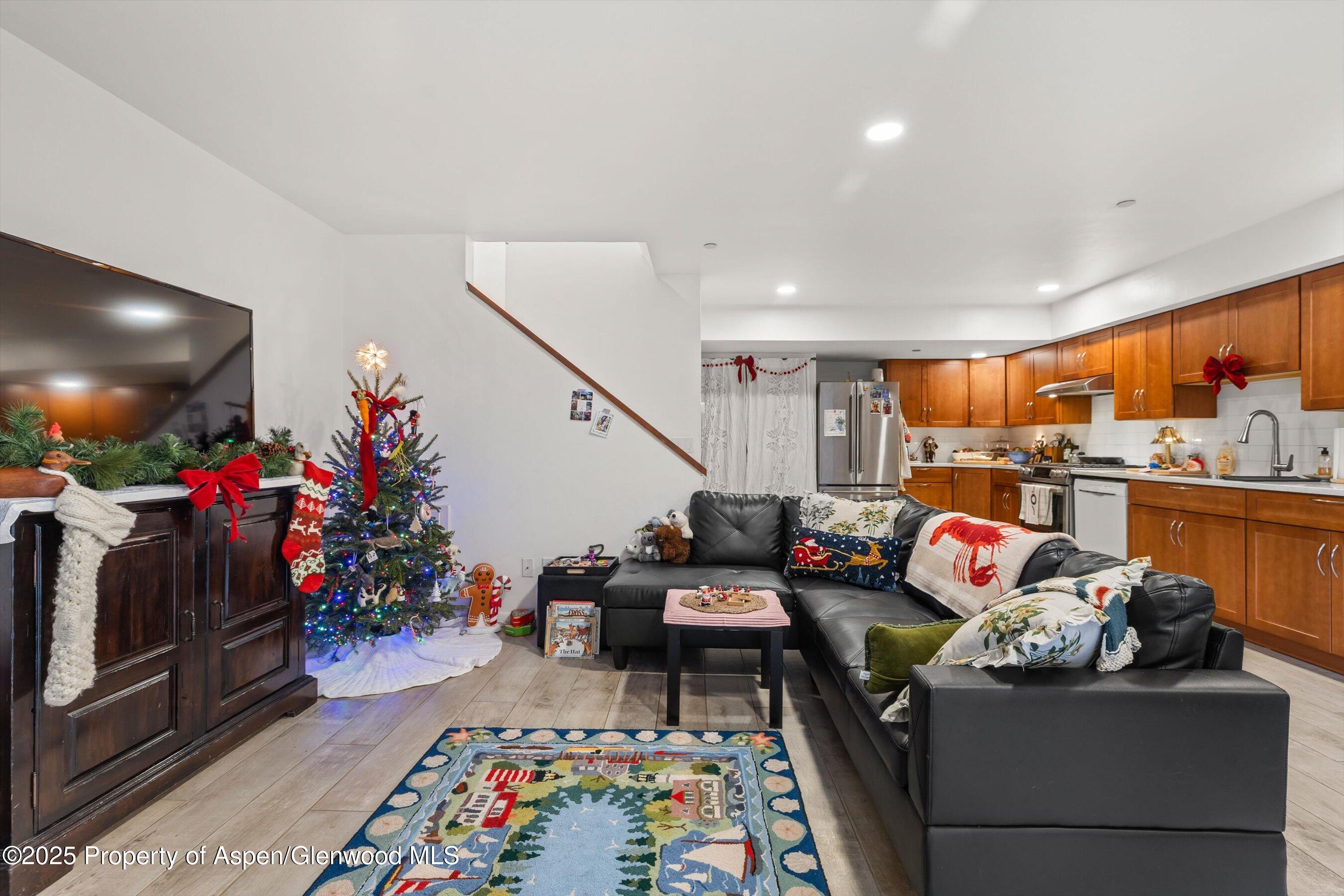 100 Midland Avenue, Unit 108 Basalt, CO 81621 - Photo 5 of 10 a living room filled with furniture and a flat screen tv