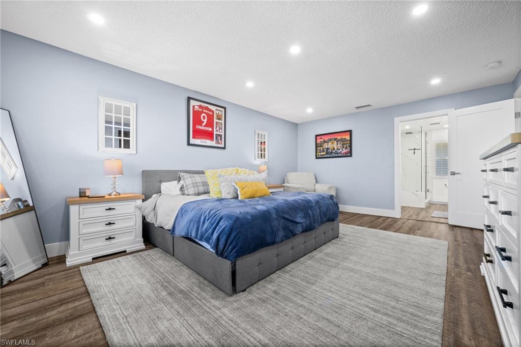 225 Memory Lane, Unit 2464 Naples, FL 34112 - Photo 8 of 29 Bedroom with recessed lighting, a textured ceiling, and dark wood-style floors